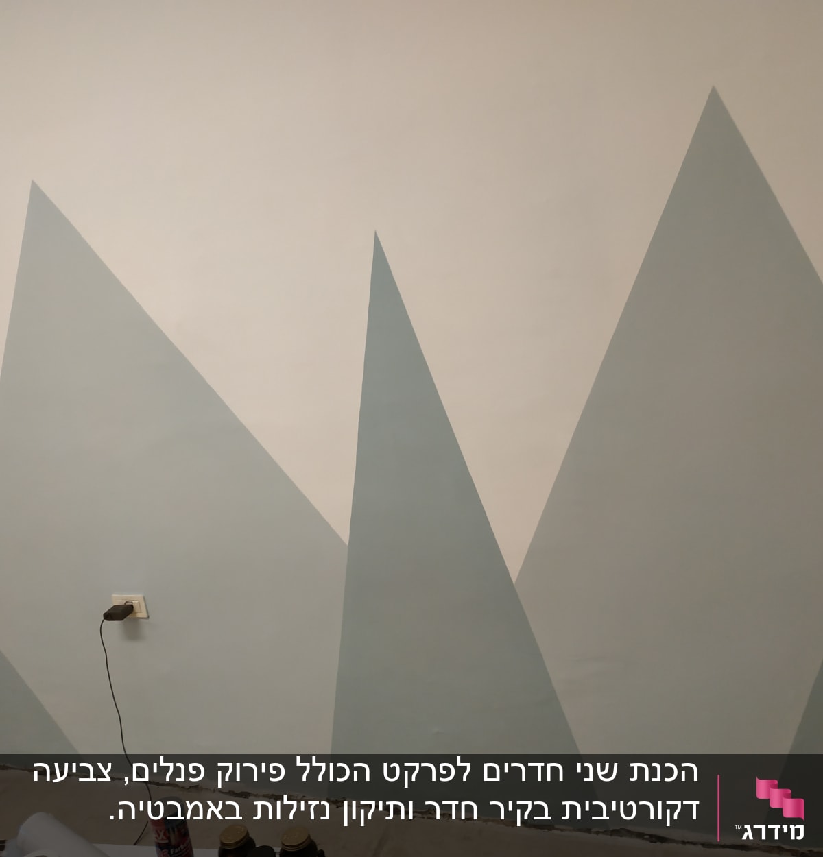 קיר צבוע בצורות גיאומטריות משולשות בגוונים שונים
